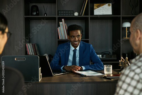 Billede på lærred Medium shot of Black male lawyer meeting divorcing couple, reviewing documents and discussing legal separation terms