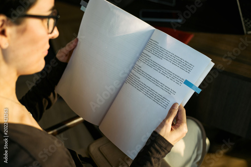 Obraz na plátne Caucasian middle aged woman reviewing legal documents, handling divorce paperwork and reading contract terms