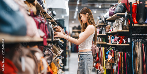 Принти на полотні Young adult woman youth culture gen Z shopping choosing used purse bags second h