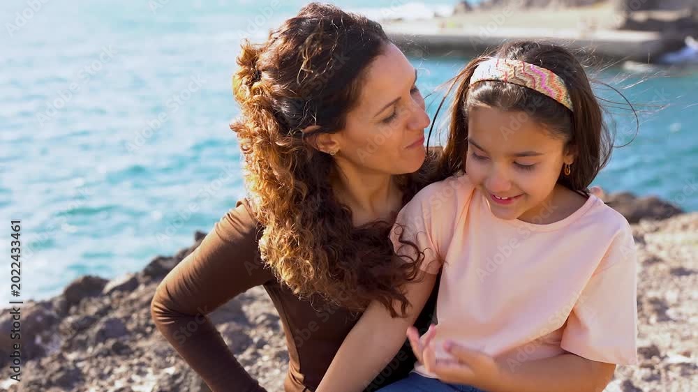Happy latin mother having fun with daughter on the beach - Mom and ...