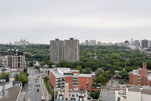 Canvas Print Panoramic city skyline with green urban area.