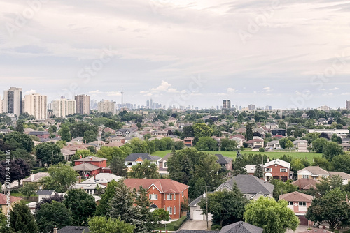 Fotografie Suburban city view under cloudy sky.
