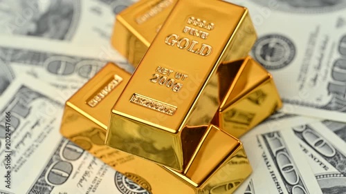 gold bars with dollar bills