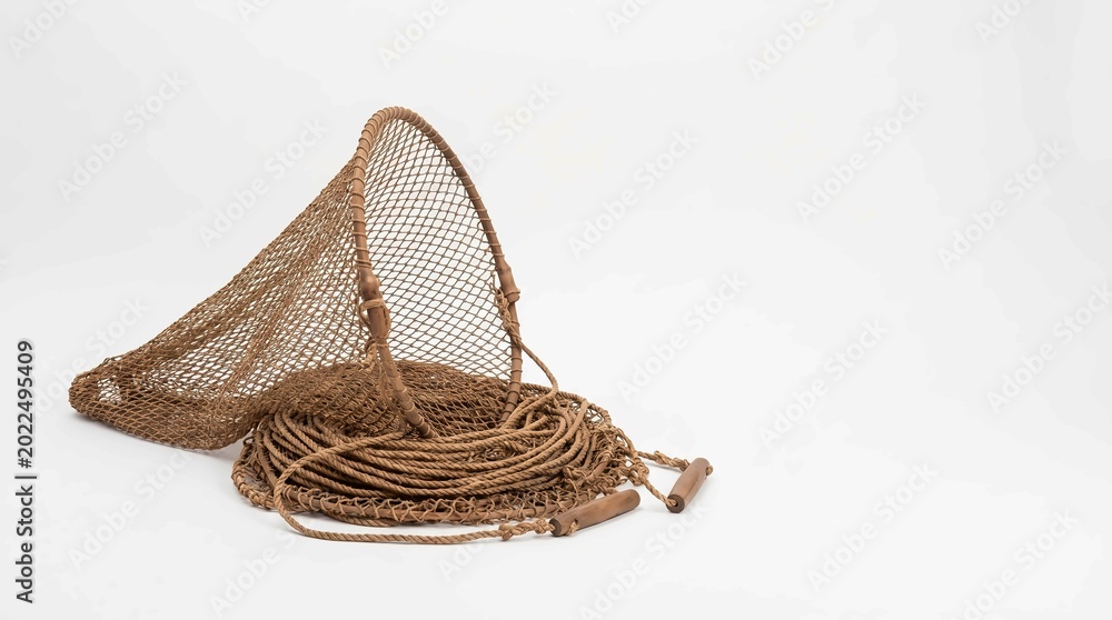 Obraz premium Golden fishing net with wooden handle on white background