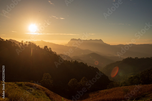Blue golden sky sunrise dramatic beautiful landscape mountain. Dramatic sunset over mountain landscape. Beautiful landscape foggy hills twilight time. Dawn sky gold dusk time cloudscape with sunlight