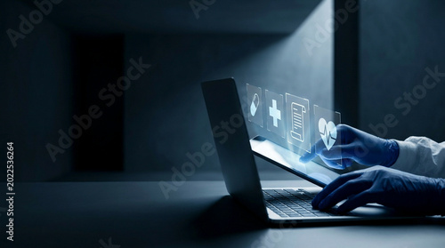 Tableau sur toile Person using laptop in dimly lit room with holographic medical data display