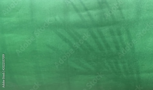 Canvastavla A close-up image of a smooth green fabric or textile material folded and draped naturally over a flat surface, showing texture and slight creases for a realistic look