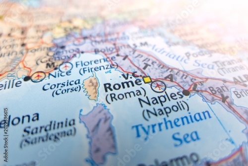 Map of Rome with flare from top right corner. Selective focus on label, close-up view