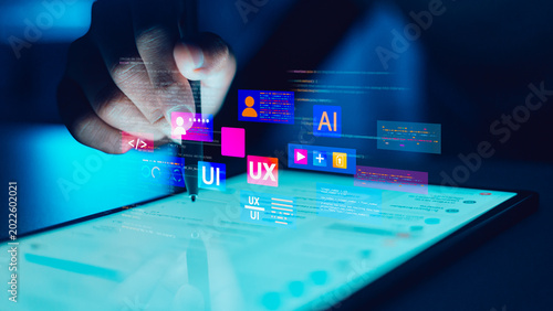 UX UI Designer using stylus pen on digital tablet for mobile app interface development and artificial intelligence programming.