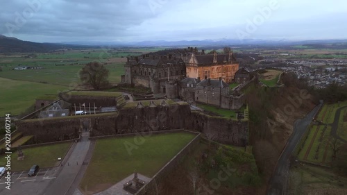 Stirling Scotland city skyline drone flyover and mountains in the distance. Clouds cover the sky, creating an atmosphere in the Scottish highlands