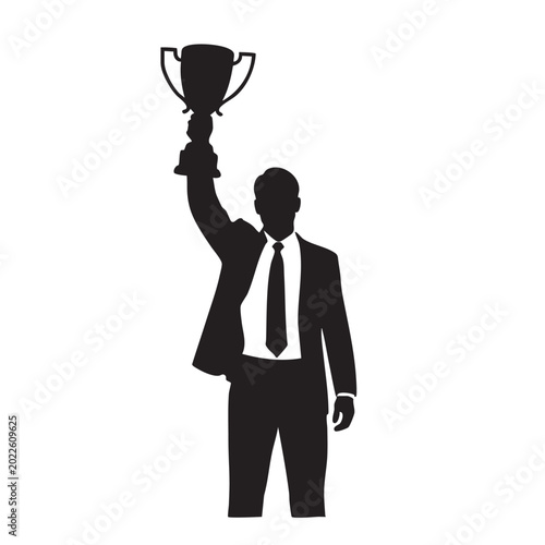 Fotografija Silhouette of a businessman holding a trophy aloft symbolizing success and achie