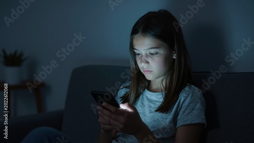 Girl Scrolling Feeds in Dim Room