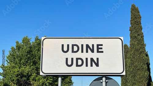 Schilderij op canvas Bilingual signage, the sign shows the name of the city in Italian, Udine, and in the Friulian language, Udin