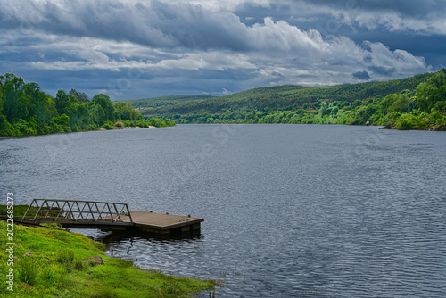 Fotografie Storm Clouds Over a Peaceful Portuguese River