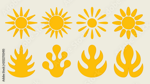Valokuva Collection of yellow sun and flame shaped silhouettes against a pale background