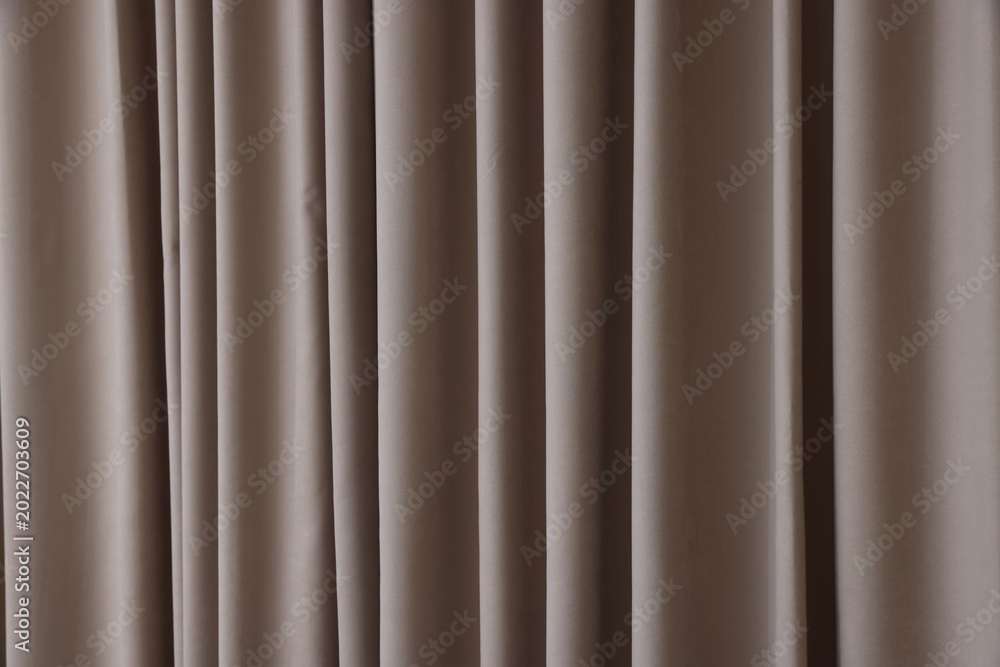 Fototapeta premium Stylish dark beige curtains as background, closeup