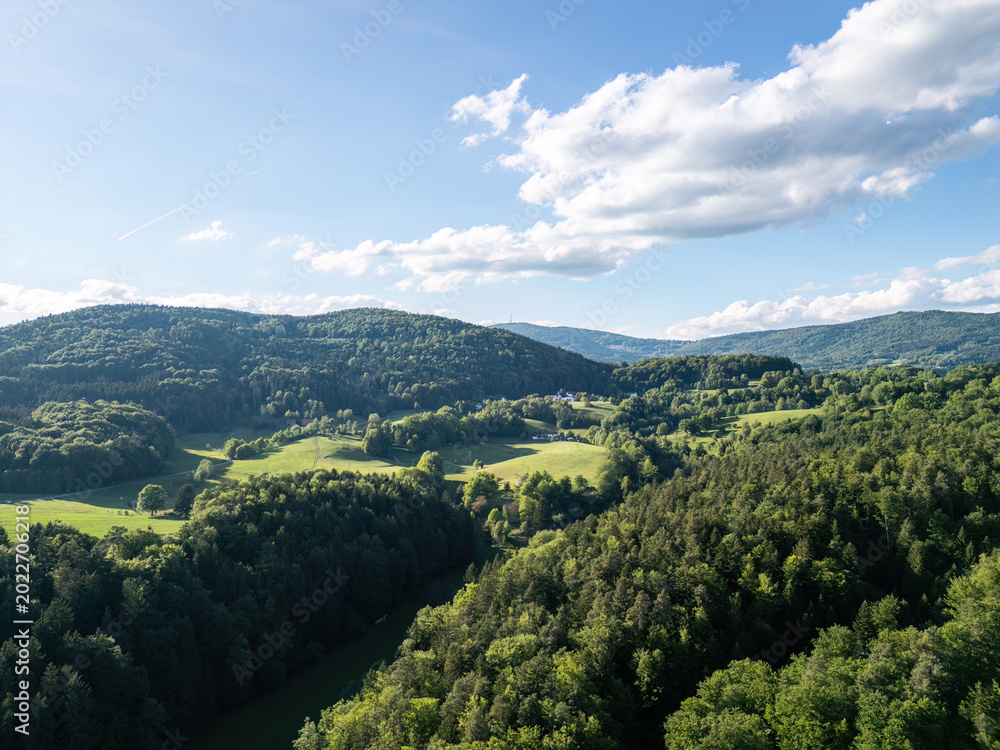 Fototapeta premium Drone view above forests, meadows and farmland in the Bavarian Forest countryside of Lower Bavaria