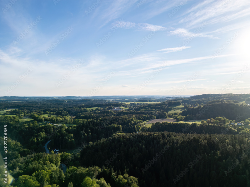 Obraz premium Drone view above forests, meadows and farmland in the Bavarian Forest countryside of Lower Bavaria