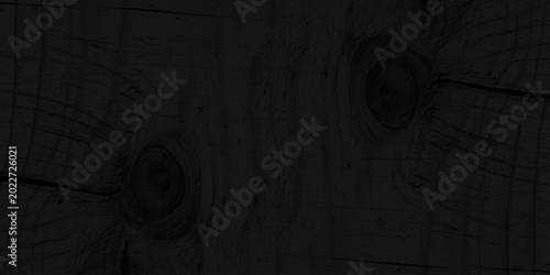 Foto Black charred wood texture background with natural organic grain and knots, dark