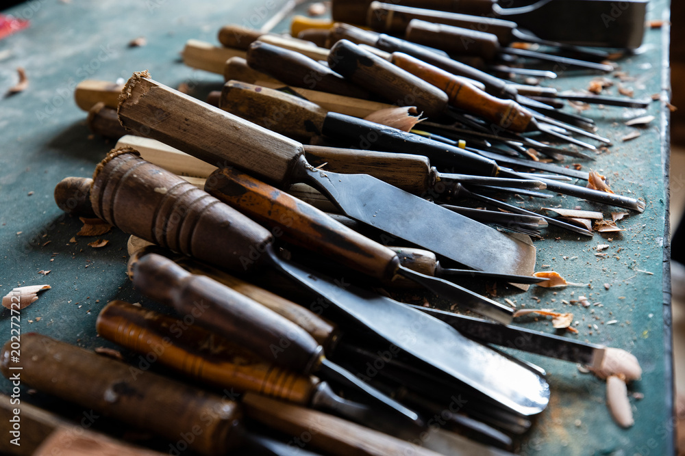 Foto Professional wood carving tools gouges and wooden mallet on an artisan workbench