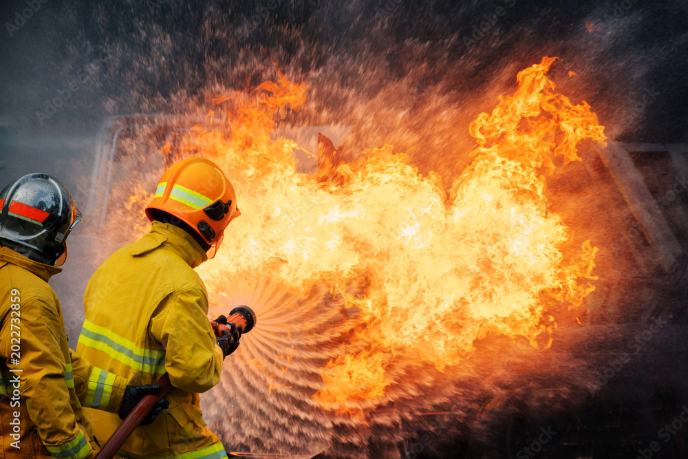 Fototapeta premium Firefighters control a large blaze at an accident scene