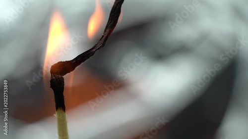 4K macro video of burning matchsticks with glowing flames and detailed charred tips.