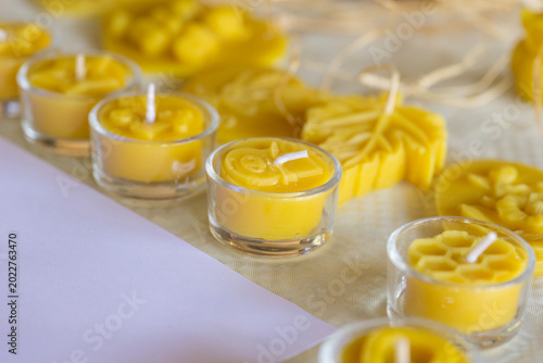 Valokuva closeup of various yellow natural beeswax candles and carved wax figures in shap