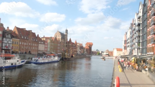 Blurred view of Gdansk old town embankment with Motlawa river and Crane, horizontal 4K