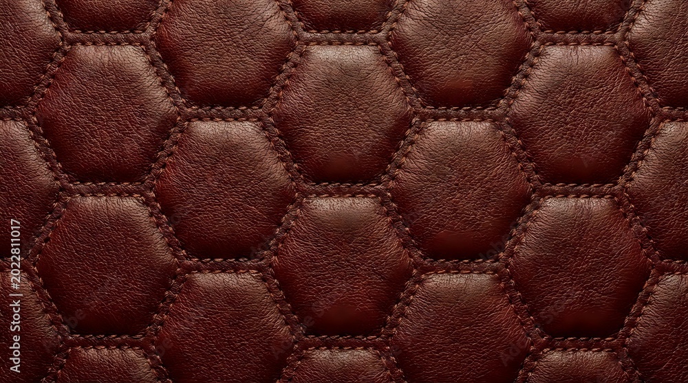 Naklejka premium Luxurious brown leather upholstery with hexagonal quilted pattern and decorative stitching for premium furniture and automotive interior design projects.