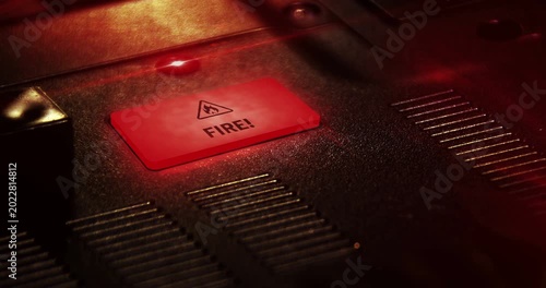 Fire alert symbol light flashing on metal panel macro view. Flame danger warning lamp sign on industrial dashboard loop. Loopable and seamless abstract icon technology concept.