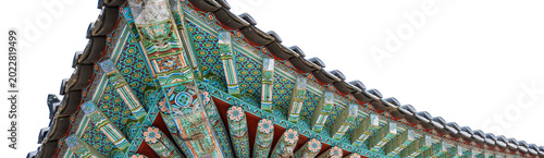 Fotografi Detailed dancheong patterns on traditional Korean palace eaves isolated on a whi
