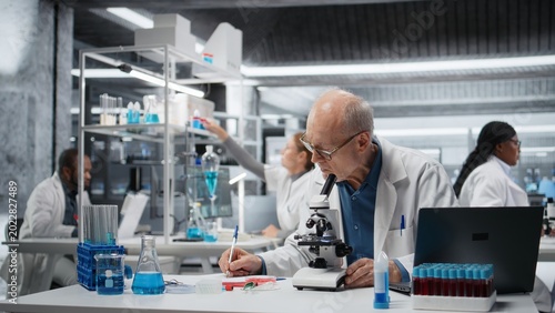 Bilde på lerret Laboratory materials scientist examining biopsy slide with microscope, logging results on clipboard