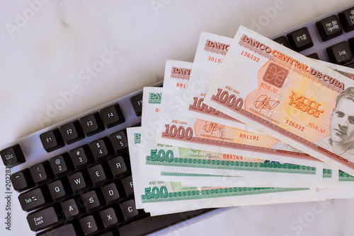Photography Mixed Cuban CUC currency notes with official denomination values on computer key