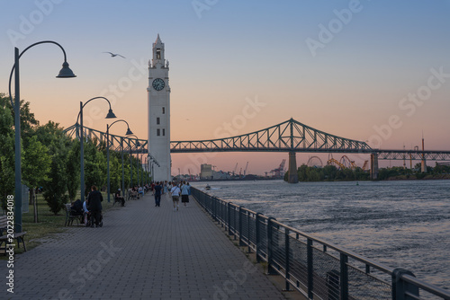 Clock Tower and Jacques-Cartier Bridge at the Old Port of Montreal waterfront at sunset - Quebec, Canada