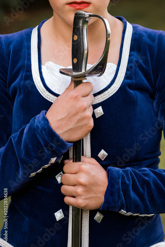 Quadro su tela Highland dancer in blue velvet jacket holding broadsword vertically before Scott