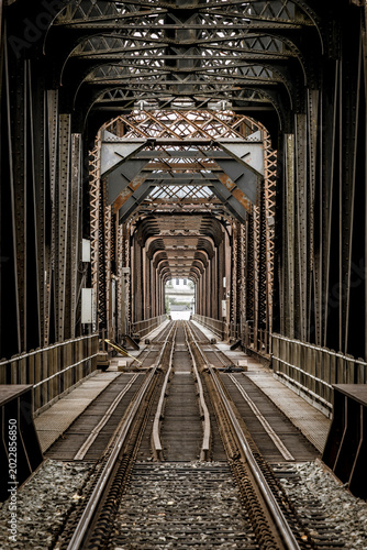 rustic old train truss bridge over a river
