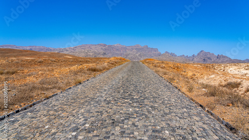 A wide panoramic view of an inhospitable place with an endless road in the center of frame, Santo Antão, Cape Verde.
