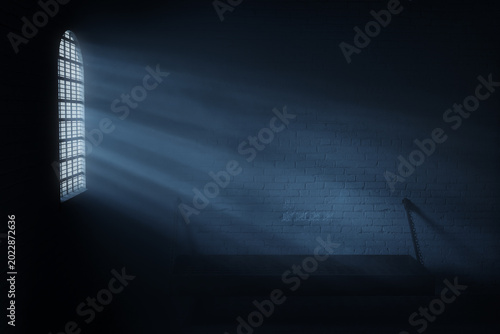 Fotografie 3d rendering of a vintage prison cell with bed and light rays through arch windo