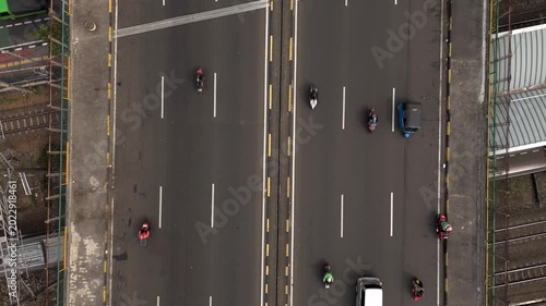 Color graded top down aerial view of city highway bridge with traffic moving on asphalt lanes