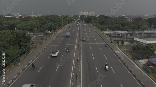 High angle view of traffic moving on a multi-lane city overpass bridge during overcast weather