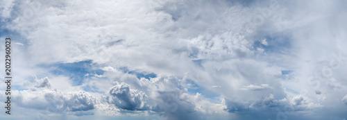 Bild auf Leinwand Dramatic Panoramic Cloudscape of Blue Sky With Layered Cumulus and Wispy Cirrus