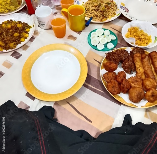 dining table with assorted dishes drinks and snacks prepared for shared meal