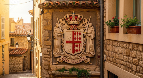 Coat of arms on old stone building in narrow European street