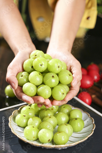 Bilde på lerret Fresh Green Wild Fruits in Hands - Natural Organic Produce with Sweet Astringent