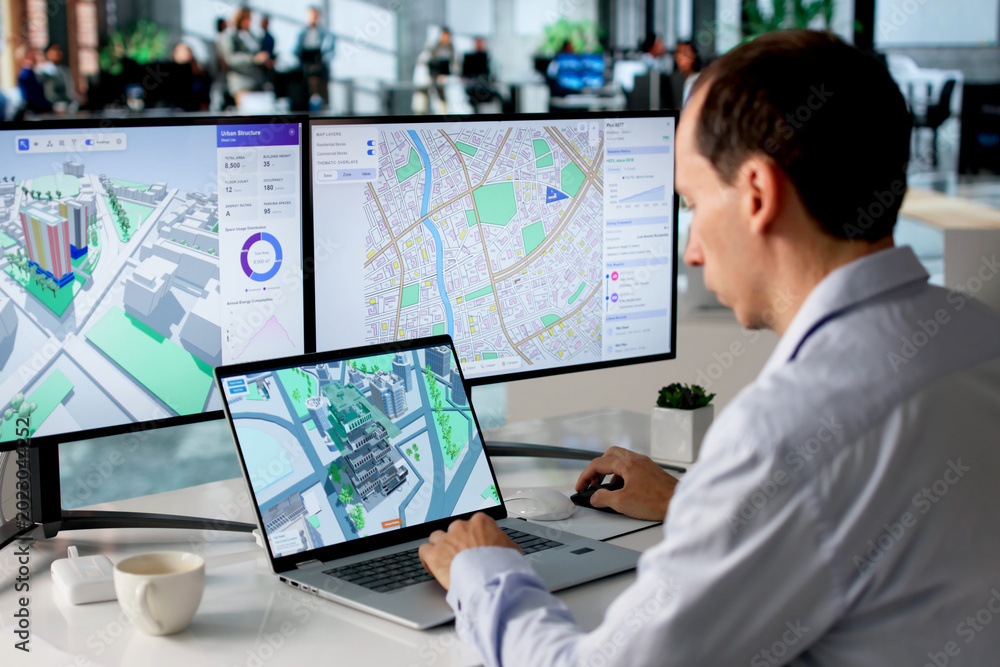 Fototapeta premium Engineer Studies Urban Property Maps On Laptop Using BIM