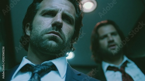 intense businessmen confrontation in an elevator with dramatic lighting