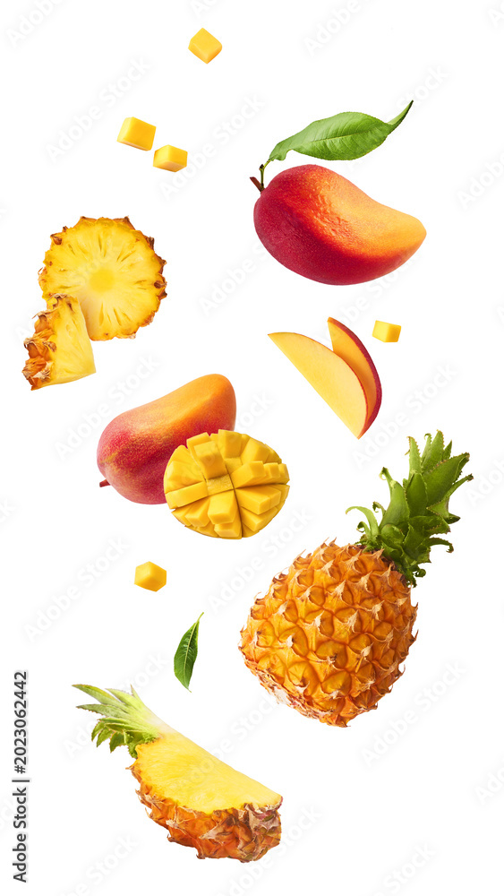 Fototapeta premium Levitating fresh tropical fruits. Sliced and whole pineapple and mango falling in the air on white background. Creative dynamic summer food composition.