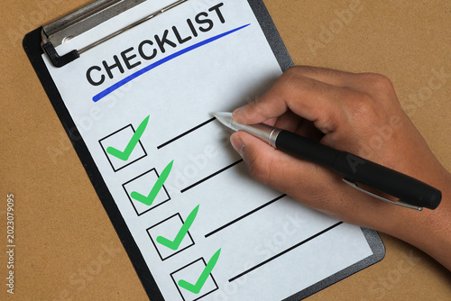 Bild auf Leinwand Business Checklist Completion with Hand Ticking Tasks on Clipboard