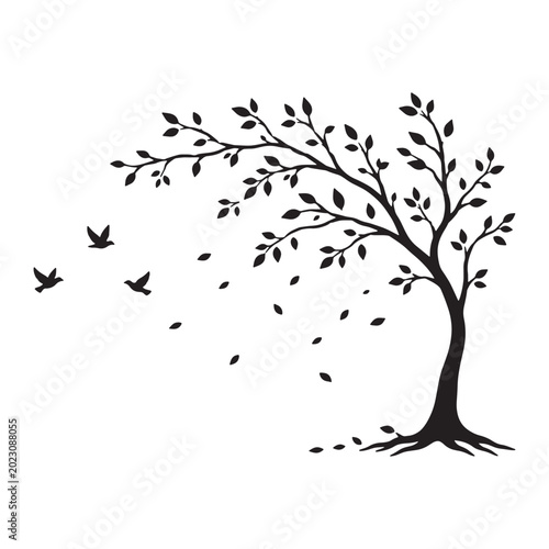 Silhouette of a deciduous tree with falling leaves and flying birds during a windy day