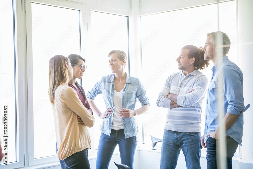 Fototapeta premium Creative business team talking together in office workspace